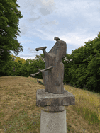 Das Kunstwerk aus Bronze steht auf der Grünfläche vor dem Wohnhaus